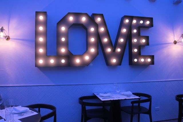 Illuminated LOVE Sign in Blue Lit Romantic Dining Setting - Download Free Stock Photos Pikwizard.com