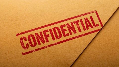 Confidential stamp on sealed kraft envelope with red ink and textured paper flap