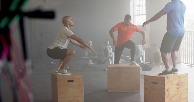 Group training with box jumps in fitness gym interior foggy atmosphere - Download Free Stock Images Pikwizard.com