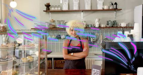Smiling barista behind bakery counter inviting customers