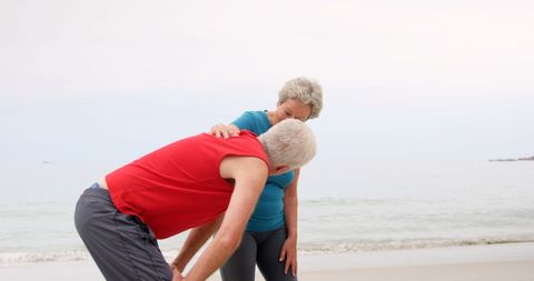 Senior Couple Outdoors with Woman Supporting Man in Relaxed Environment