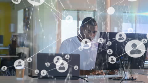 Businessman Using Laptop with Digital Connections Overlay in Modern Office