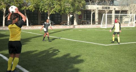 Teen Soccer Players Practicing Passing on Outdoor School Field