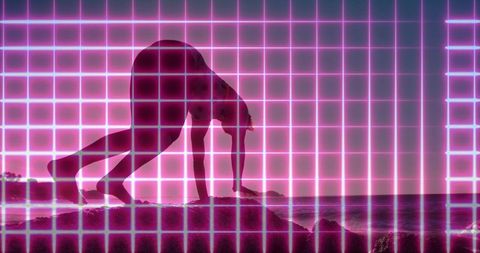 Neon magenta grid silhouette crawling on ocean rocks at dusk, futuristic retro yoga pose