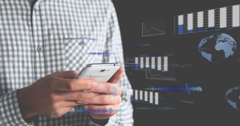 Businessman interacting with financial graphs on smartphone