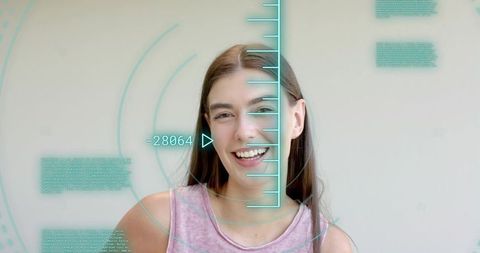 Smiling woman in pink top with turquoise ar hud overlay for facial scan