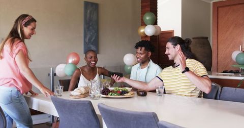 Friends Laughing Over Smartphone at Casual Indoor Gathering