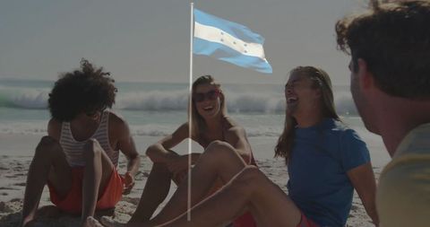 Friends Relaxing Beach Vibes under Blue Flag Parade