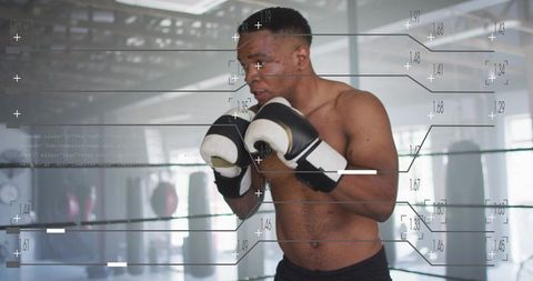 Boxer training in industrial gym with digital HUD overlays illustrating performance metrics