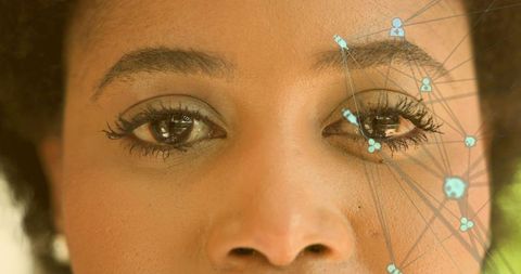 Closeup woman displaying bold eyeliner and long lashes with teal node-and-link overlay