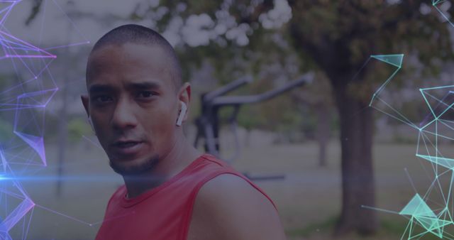 Young man in red tank top exercising outdoors with wireless earphones - Download Free Stock Images Pikwizard.com