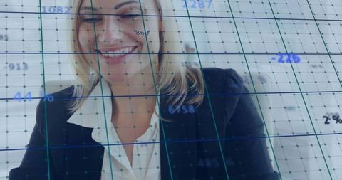 Smiling businesswoman analyzing transparent digital data grid on corporate dashboard