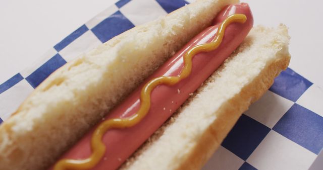 Image of hot dog with mustard on a white surface. food, cuisine and catering ingredients.