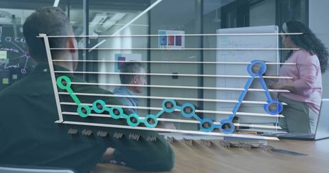 Team presenting sales line chart overlay in glass meeting room with woman reviewing data