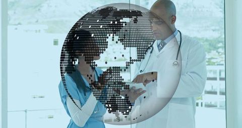 Healthcare team reviewing tablet with global data visualization in modern clinic