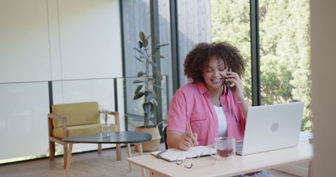 African American Woman Multitasking in Modern Home Office