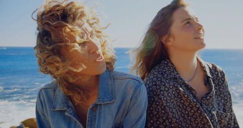 Carefree Friends Enjoying Beach Sunlight