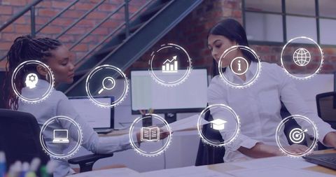 Coworkers collaborating on data review in modern brick office with analytics icons