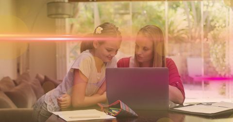 Mother and Daughter Bonding Time with Laptop in Bright Living Room