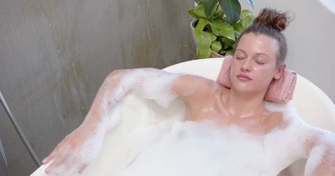 Relaxed Woman Soaking in Luxurious Bubble Bath