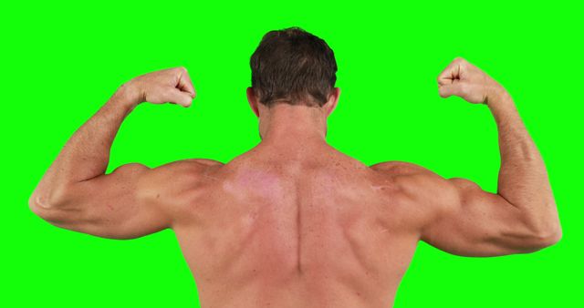 Rear view of caucasian strong man flexing muscles with copy space on green screen. Strength and fitness concept.