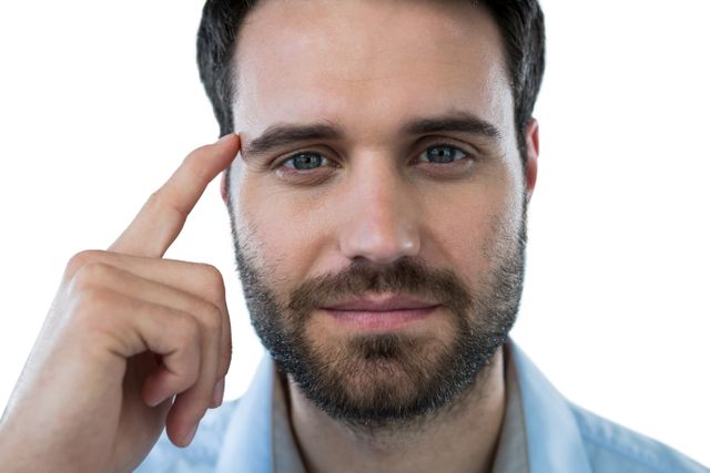 Man pointing to his head, suggesting thinking or an idea. Useful for concepts related to intelligence, brainstorming, problem-solving, or mental health. Ideal for educational, motivational, or business-related content.