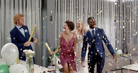 Joyful Wedding Celebration with Multiracial Friends Throwing Confetti