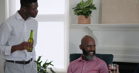 Diverse Friends Relaxing with Drinks and Conversation at Home