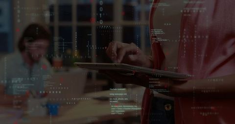 Businesswoman holding tablet while coding in modern office