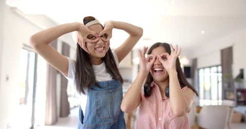Joyful Girls Playing with Hand Gestures at Home