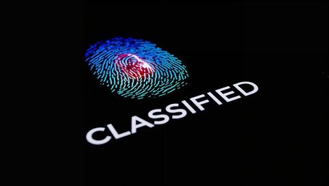 Glowing Biometric Fingerprint Hovering Above CLASSIFIED on Backlit Touchscreen
