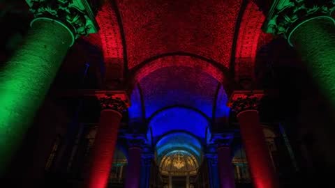 RGB LED lighting transforming basilica nave, highlighting arches, vaults, columns, apse