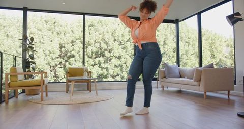 Woman Dancing Joyfully in Bright Modern Living Room