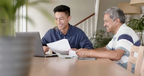 Happy Financial Advisor Helps Senior With Retirement Planning at Home