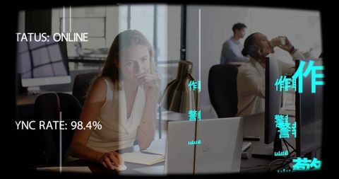 Concentrating businesswoman working at laptop in open office with hud overlay and coworkers