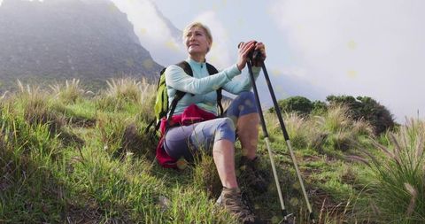 Woman Hiking Through Majestic Mountain Landscape at Golden Hour