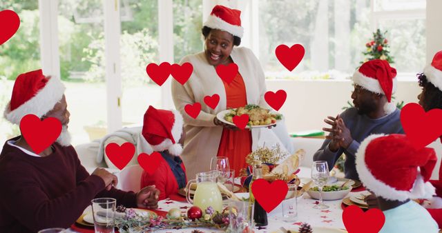 Family gathered around a dining table while celebrating Christmas. Everyone is wearing Santa hats and smiling joyfully. Perfect for depicting family togetherness during holiday season, Christmas card designs, holiday marketing flyers, festive social media posts, and articles about holiday traditions.
