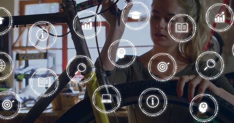 Woman mechanic adjusting bicycle wheel in workshop with ux overlays suggesting smart repair