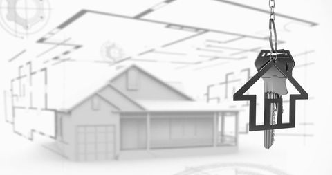 Key hanging over architectural blueprint symbolizes home ownership