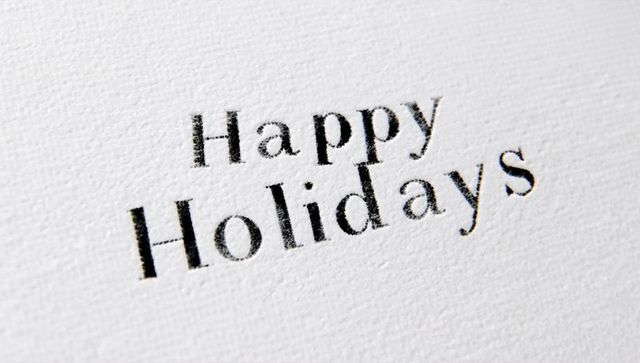 Happy Holidays Letterpress on Textured White Cardstock Closeup Minimalist Serif Typography