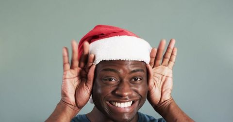 African American Man Joyfully Wearing Festival Santa Hat
