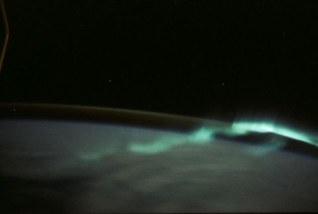 NASA astronaut Owen K. Garriott captures stunning view of southern aurora from Skylab 3 space station in 1973. Four-second exposure showcasing luminous bands over Southern Hemisphere. Ideal for use in educational materials, historical documents, and articles on astronomy, space exploration, and NASA missions.
