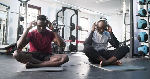 Father and Son Headphone Meditation in Gym