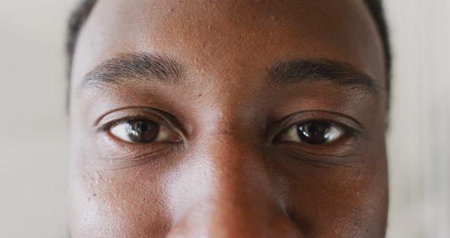 This close-up captures the intense and expressive gaze of a man. The detailed texture of the skin, eyebrows, and eyes adds depth to the image. Perfect for use in projects focused on human emotions, eye contact, facial expressions, and diverse representations.
