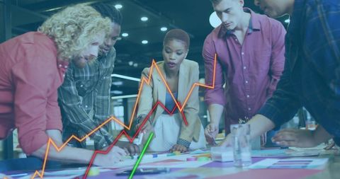 Diverse team strategizing with data visualization in modern office