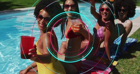 Four Friends Raising Drinks Poolside in Colorful Swimwear Celebrating Sunny Backyard Summer
