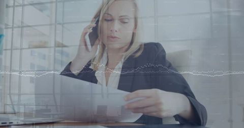 Focused Businesswoman Talking on Phone Analyzing Documents