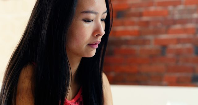 Thoughtful Young Woman Deep in Concentration Indoors - Download Free Stock Images Pikwizard.com