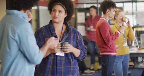 Casual office breakroom collaboration with diverse coworkers