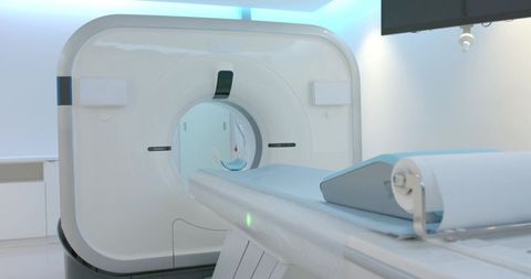 Modern ct scanner sterile radiology room with patient table, headrest and blue lighting